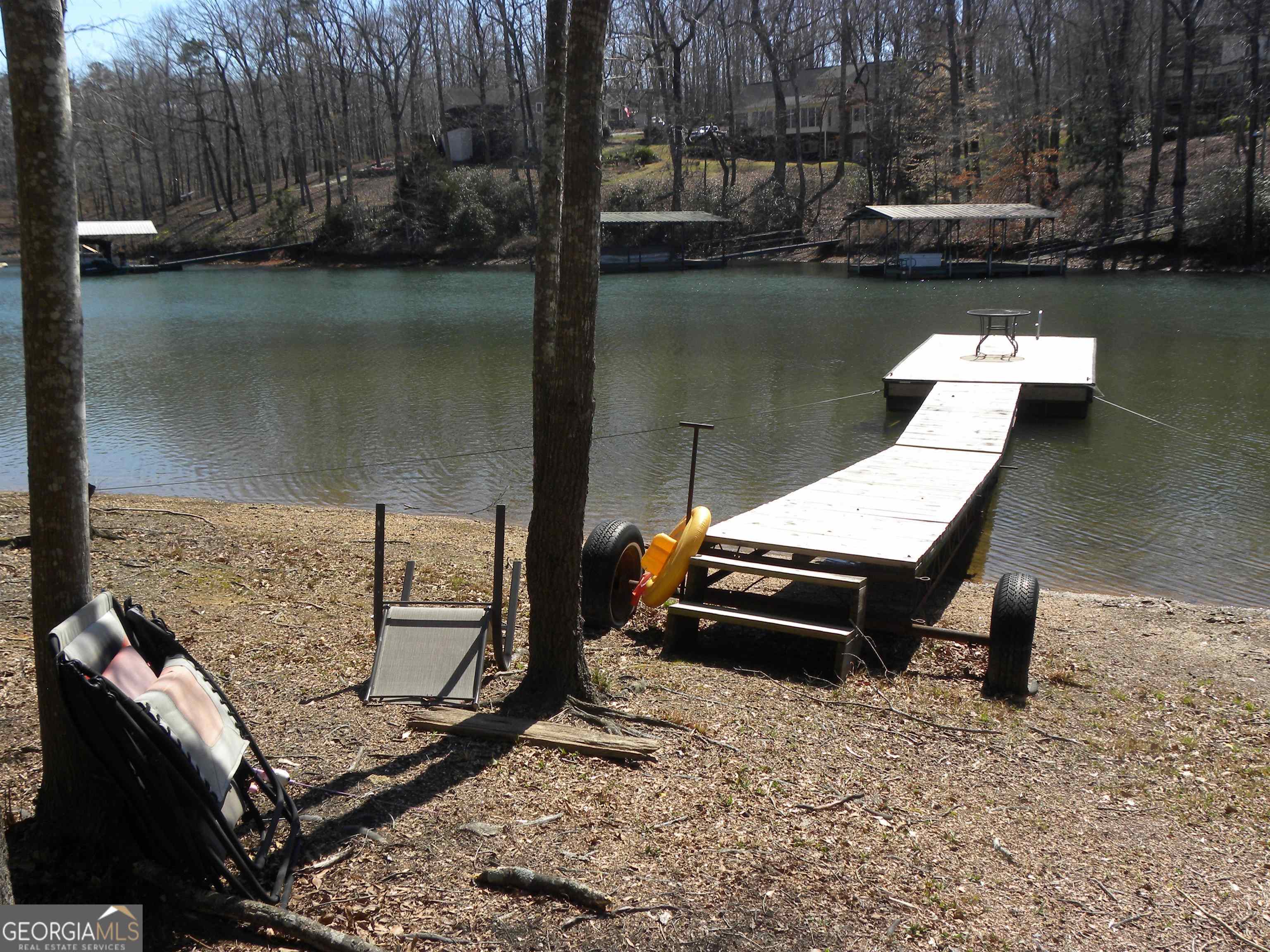 101 And 103 Joy Lane, Unit DUPLEX Hartwell, GA 30643 - Photo 10 of 24 a view of a wooden chairs and table in the lake