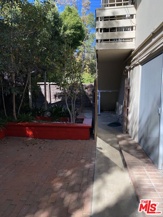 16464 Sunset Boulevard Pacific Palisades, CA 90272 - Photo 12 of 13 a view of a house with a yard