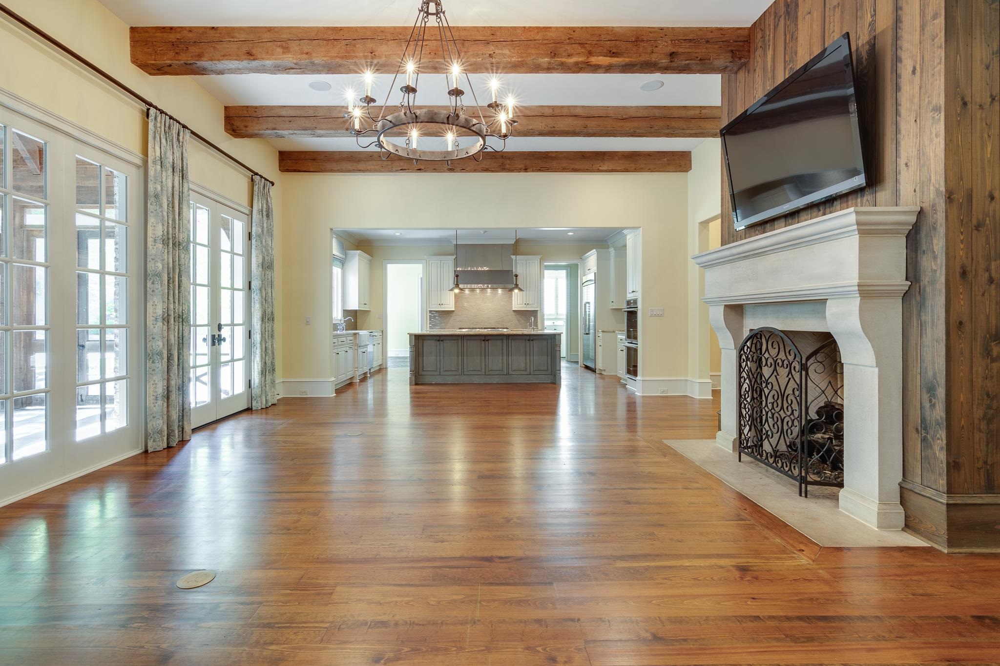 4761 Shady Grove Road Memphis, TN 38117 - Photo 4 of 25 a view of a livingroom with a fireplace wooden floor and a kitchen view