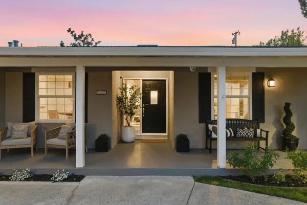 a view of a hallway with dining room and chandelier