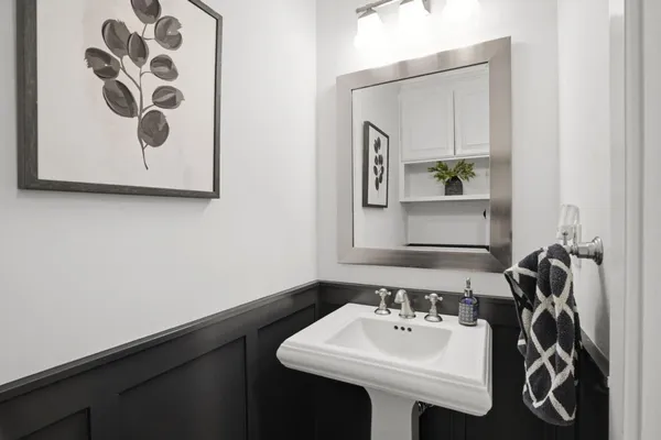 a view of a lake with a house and pool in the back