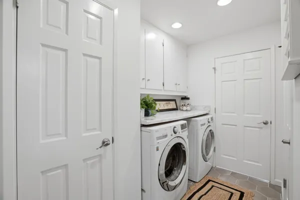 a view of a swimming pool with a patio and a yard