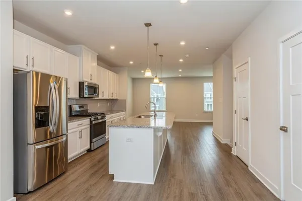 a kitchen with stainless steel appliances a refrigerator sink and stove