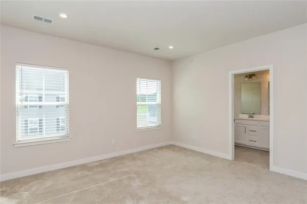 an empty room with windows and closet