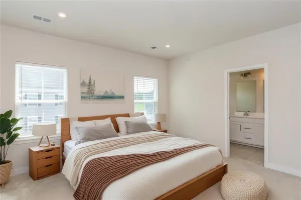 a bedroom with a bed and a potted plant