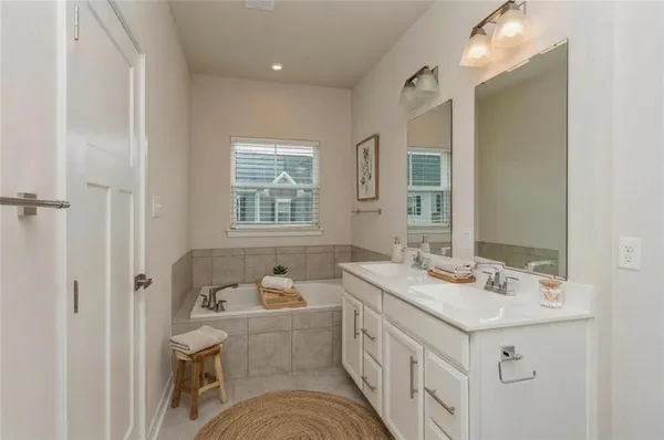 a bathroom with a sink double vanity and a bathtub