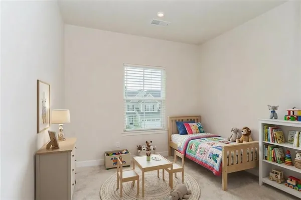 a bedroom with a bed and a book shelf