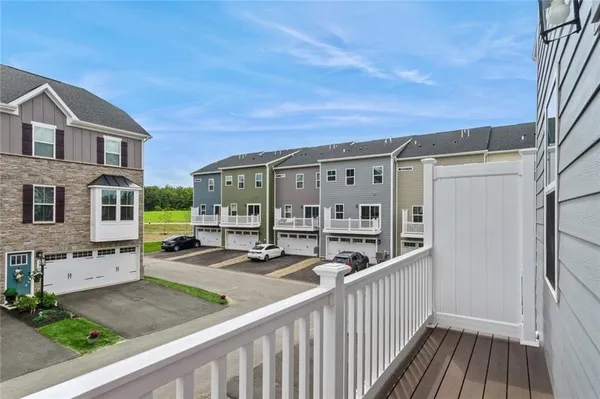 a view of a house with wooden deck and a yard