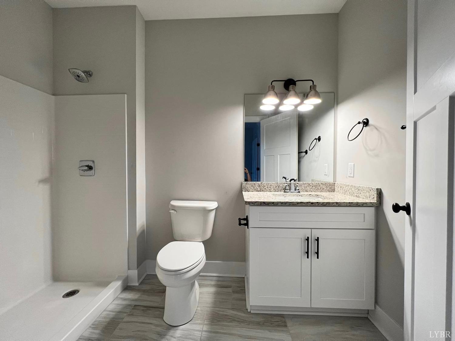 1300 Stoney Ridge Boulevard, Unit 101 Forest, VA 24551 - Photo 15 of 18 a bathroom with a sink toilet and shower