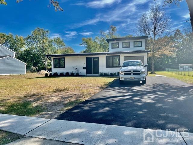 13 Emerald Road Kendall Park, NJ 08824 - Photo 1 of 24 a view of house with outdoor space and swimming pool