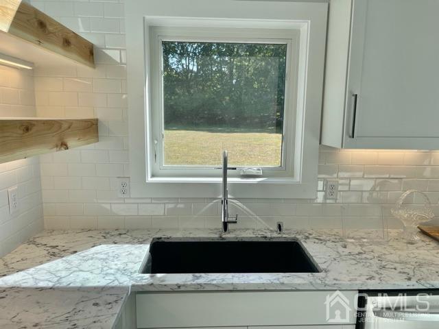 13 Emerald Road Kendall Park, NJ 08824 - Photo 11 of 24 a close up of a faucet a sink and a window