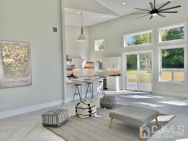 13 Emerald Road Kendall Park, NJ 08824 - Photo 6 of 24 a living room with furniture a flat screen tv and a large window