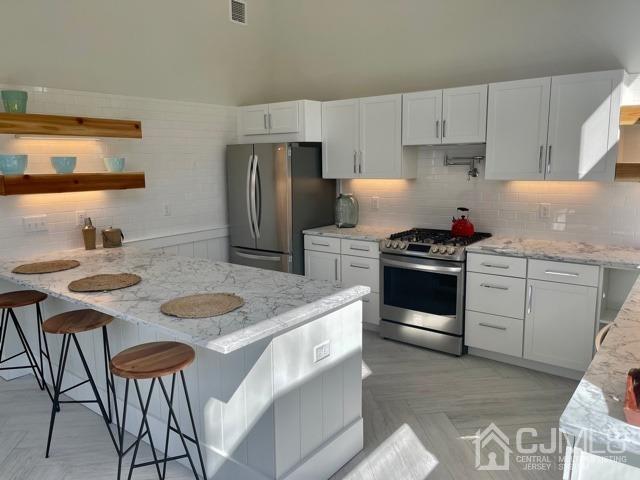 13 Emerald Road Kendall Park, NJ 08824 - Photo 9 of 24 a kitchen with stainless steel appliances granite countertop a sink and white cabinets