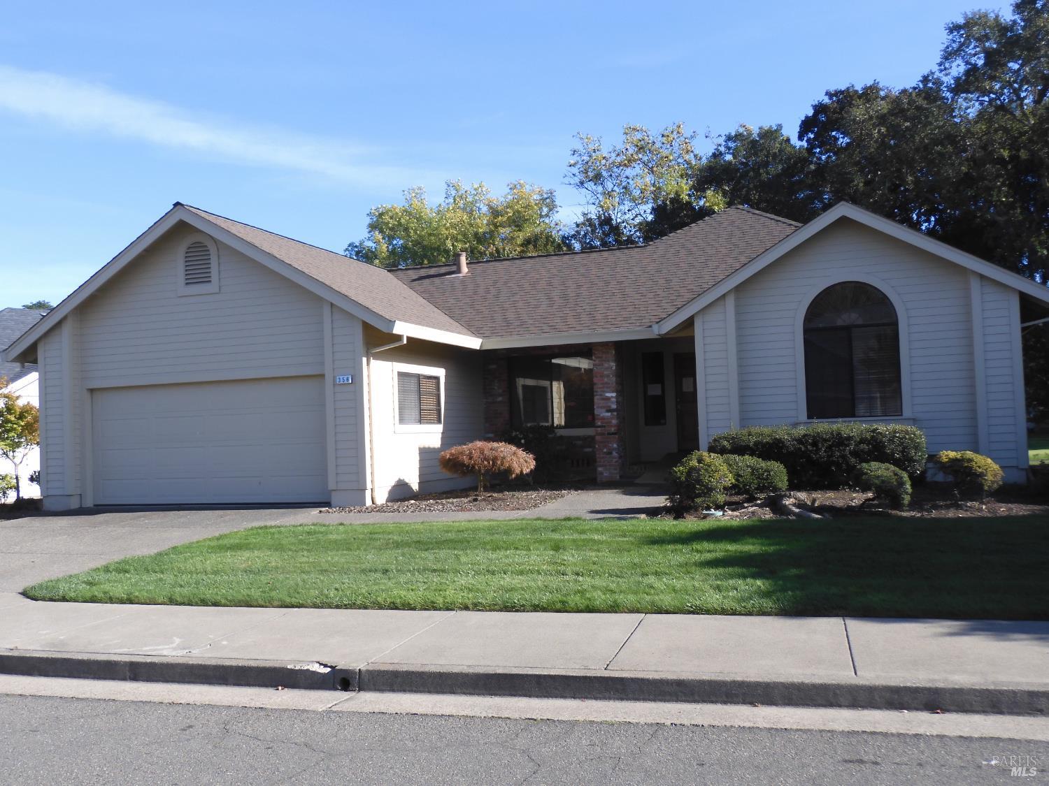 356 Singing Brook Circle Santa Rosa, CA 95409 - Photo 1 of 36 a front view of a house with a yard and garage