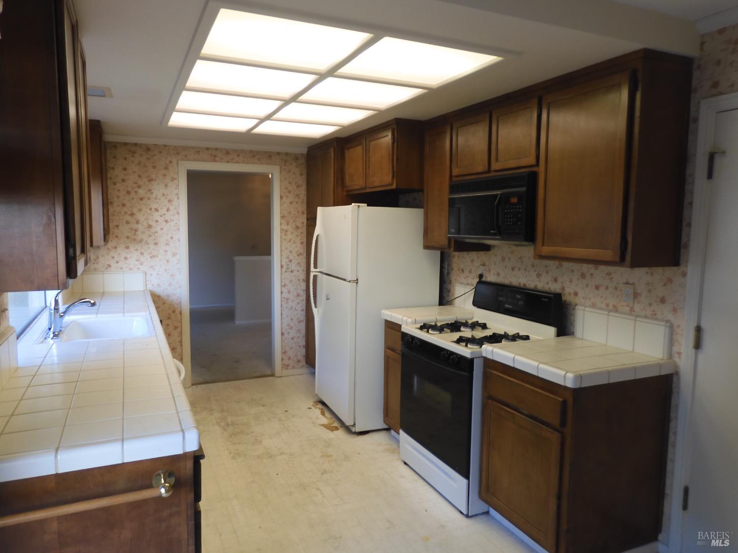 356 Singing Brook Circle Santa Rosa, CA 95409 - Photo 8 of 36 a kitchen with a refrigerator sink and stove
