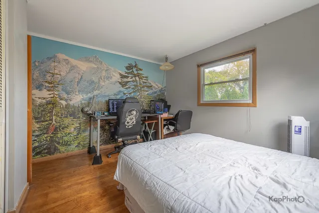 a bed sitting in a bedroom next to a window