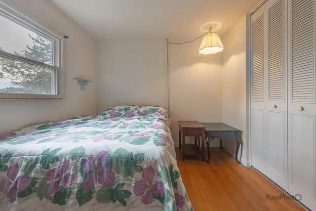 a bedroom with a bed and a table in it