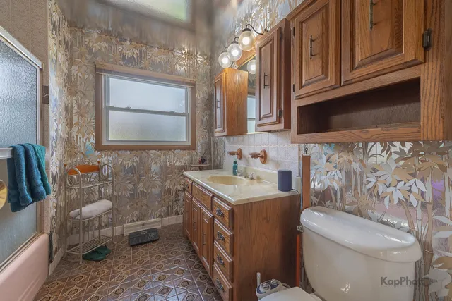 a bathroom with a sink a toilet and mirror