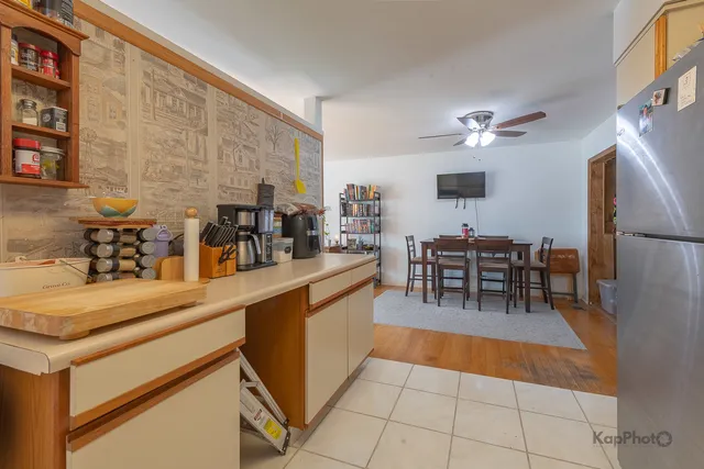 a kitchen with stainless steel appliances granite countertop a sink and a refrigerator