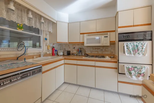 a kitchen with cabinets and window