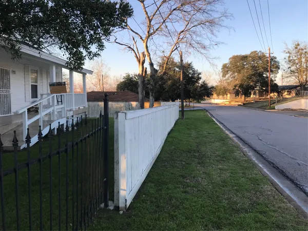 a view of a pathway of a house with a yard