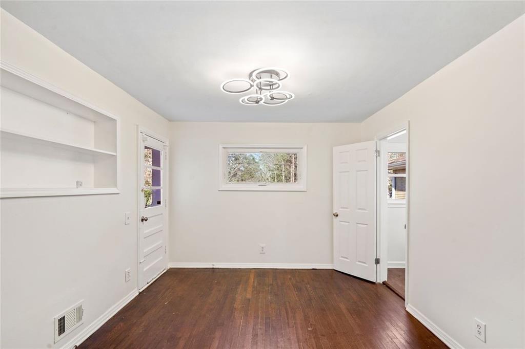 1321 Snapfinger Road Decatur, GA 30032 - Photo 17 of 22 an empty room with wooden floor and cabinet