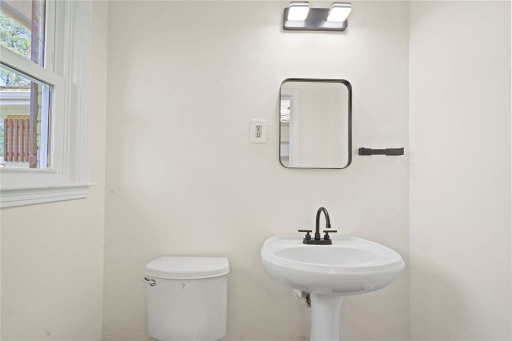 1321 Snapfinger Road Decatur, GA 30032 - Photo 18 of 22 a bathroom with a toilet sink and mirror