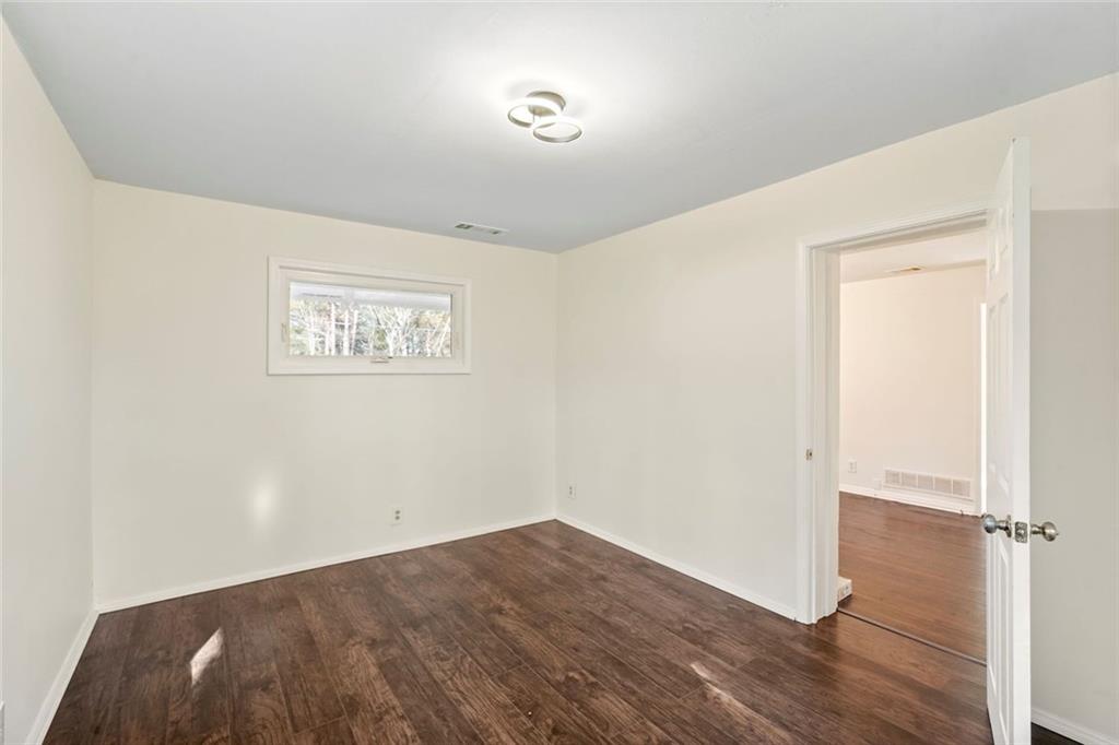 1321 Snapfinger Road Decatur, GA 30032 - Photo 20 of 22 an empty room with wooden floor and windows