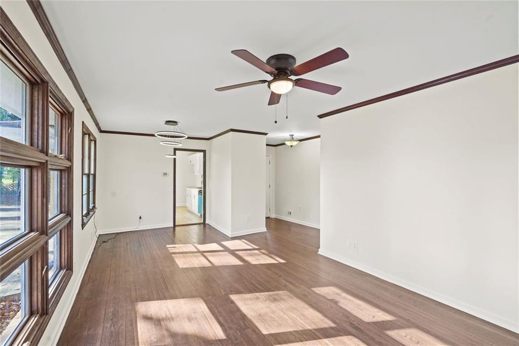 1321 Snapfinger Road Decatur, GA 30032 - Photo 6 of 22 a view of a hallway with wooden floor and a ceiling fan