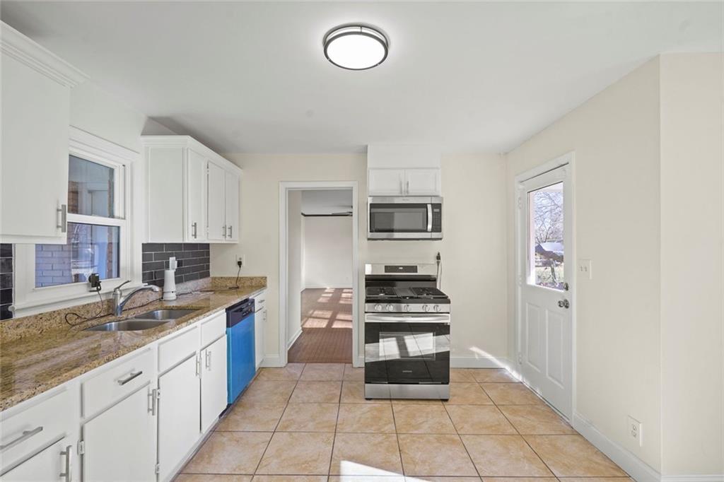 1321 Snapfinger Road Decatur, GA 30032 - Photo 7 of 22 a kitchen with stainless steel appliances a stove top oven and cabinets