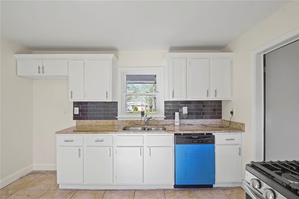 1321 Snapfinger Road Decatur, GA 30032 - Photo 9 of 22 a kitchen with stainless steel appliances granite countertop a sink stove and cabinets