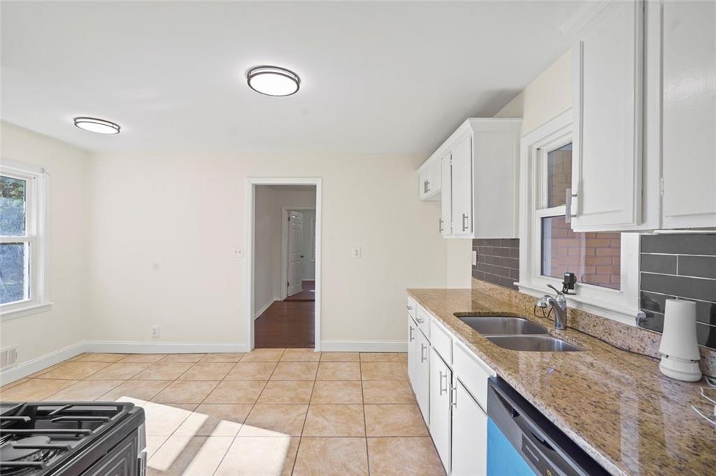 1321 Snapfinger Road Decatur, GA 30032 - Photo 10 of 22 a kitchen that has a sink and a stove