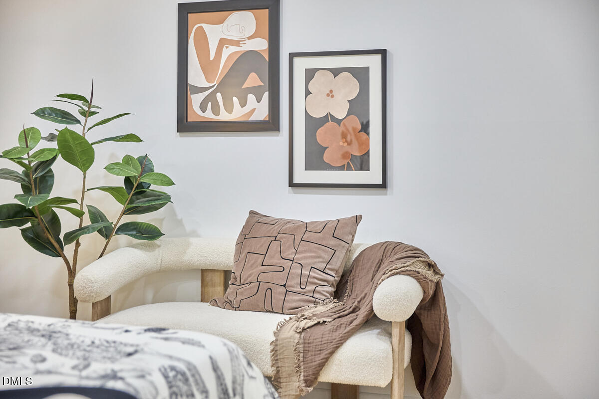 2613 McNeil Street, Unit E Raleigh, NC 27608 - Photo 24 of 28 a bedroom with bed and a potted plant