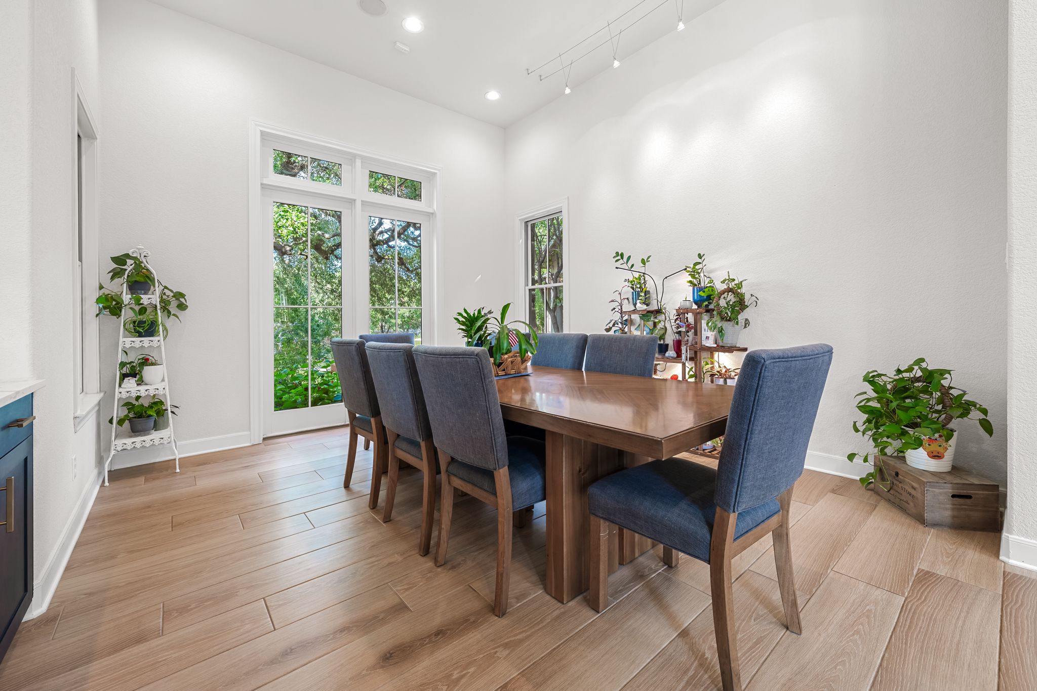 195 Desert Flower Spring Branch, TX 78070 - Photo 12 of 40 Dining area featuring wood-finish flooring, high ceilings, recessed lighting, and a large glass-paned door opening to exterior greenery
