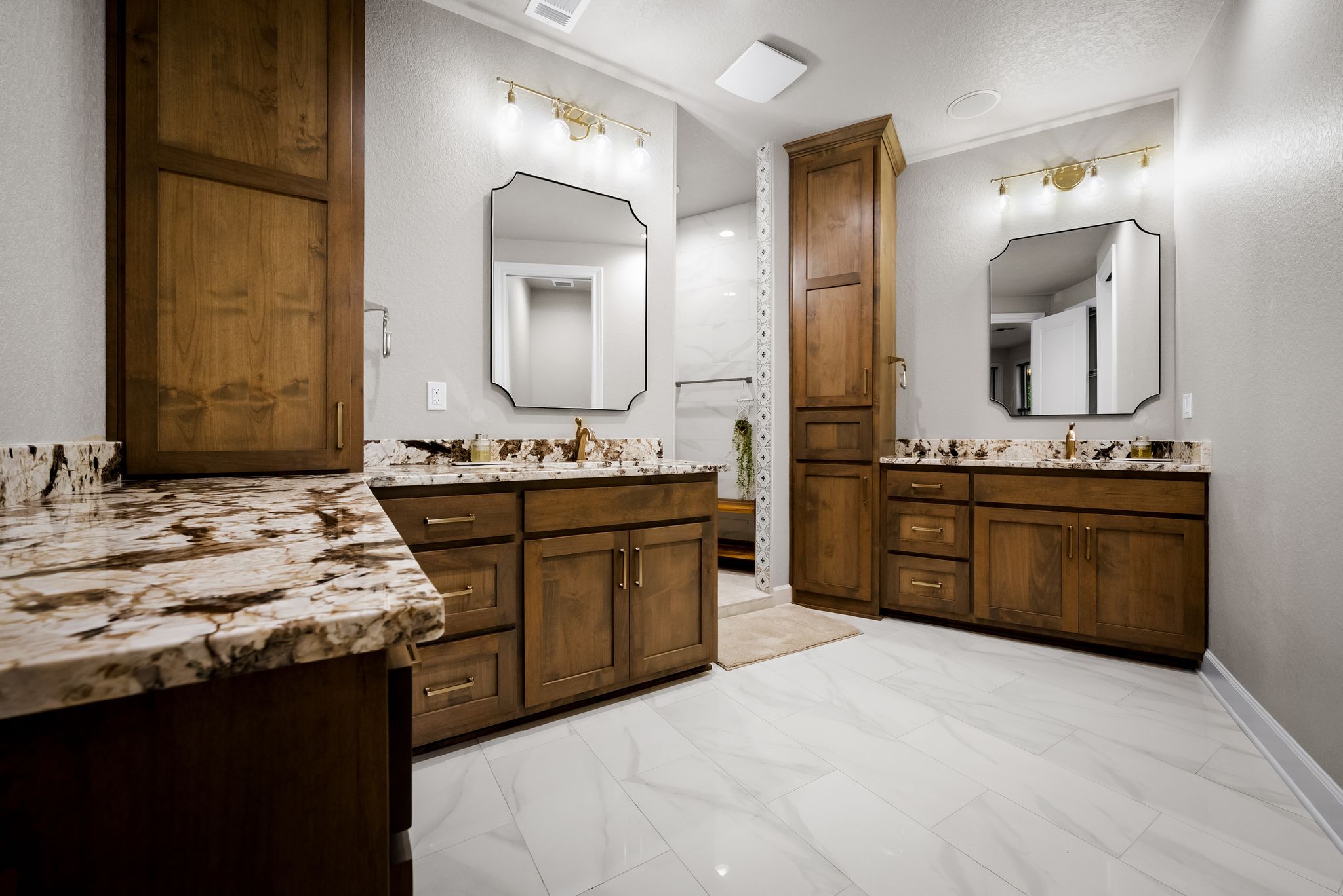 195 Desert Flower Spring Branch, TX 78070 - Photo 16 of 40 Dual vanity bathroom featuring wood-finish cabinetry, patterned stone countertops, and white tile flooring