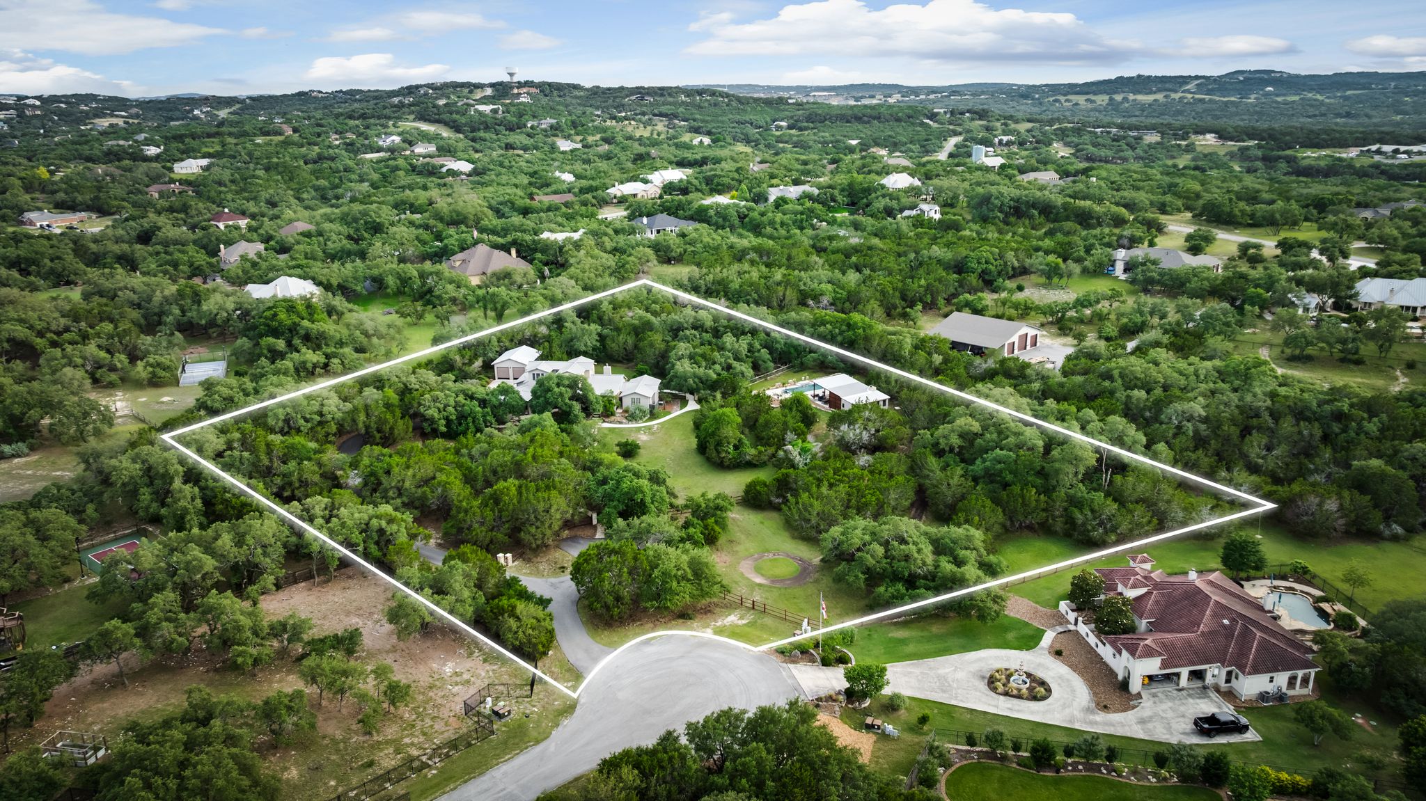 195 Desert Flower Spring Branch, TX 78070 - Photo 2 of 40 Expansive property featuring a cul-de-sac entry, mature trees, and multiple structures