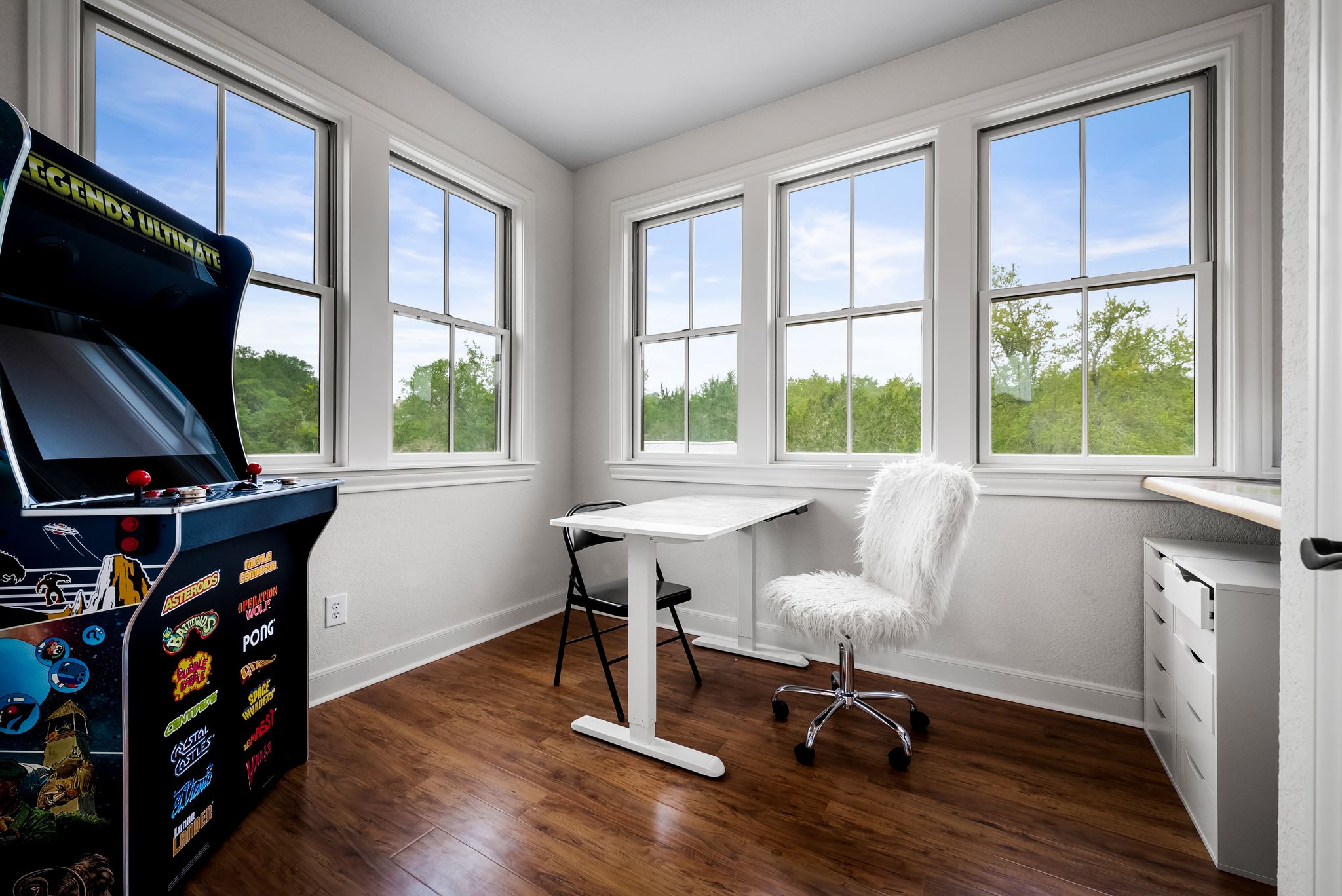 195 Desert Flower Spring Branch, TX 78070 - Photo 24 of 40 Bright room featuring wood-finish flooring, white baseboards, and multiple large windows with white trim