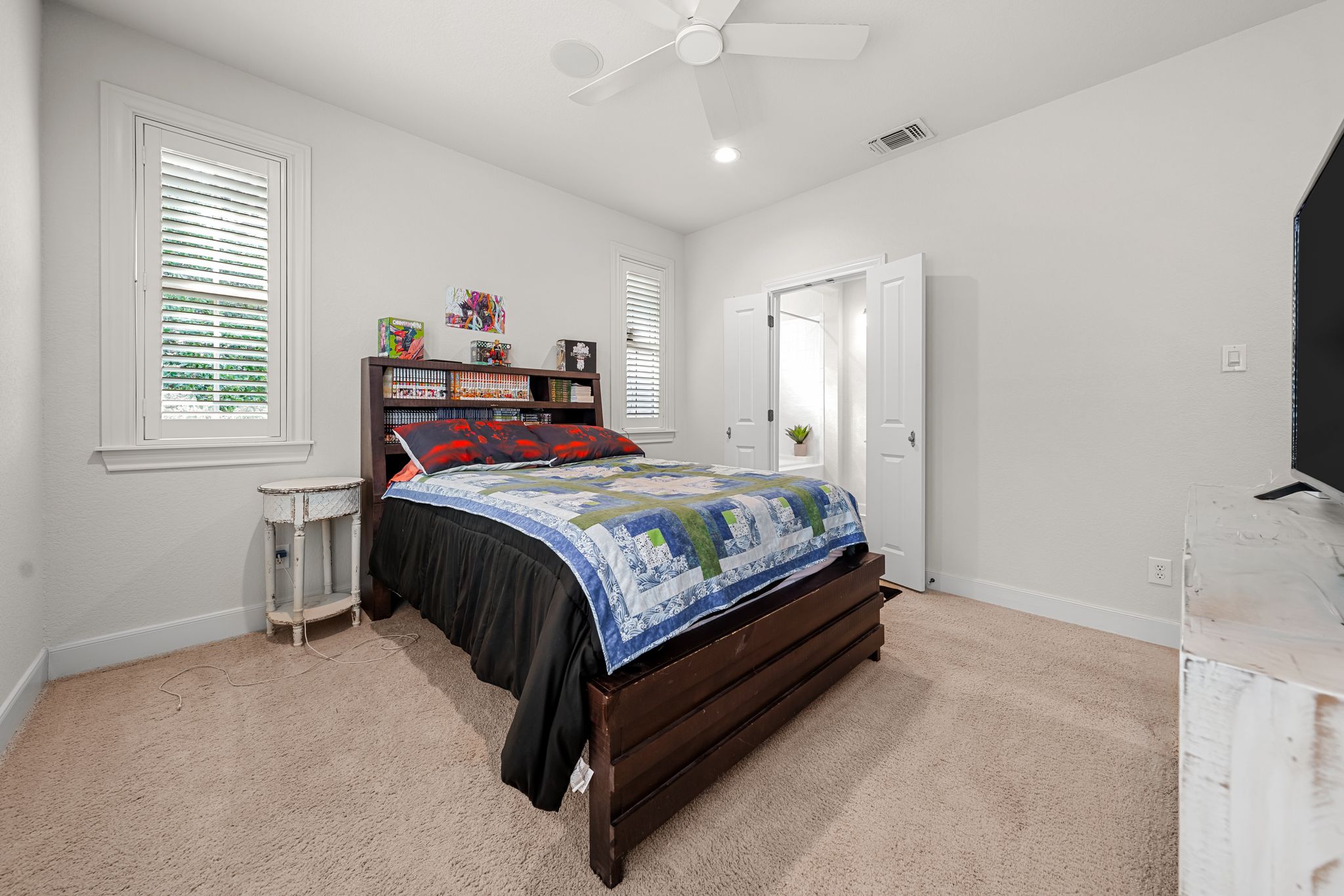 195 Desert Flower Spring Branch, TX 78070 - Photo 25 of 40 Carpeted room with white walls, two white-framed windows with louvered blinds, and a ceiling fan with integrated lighting