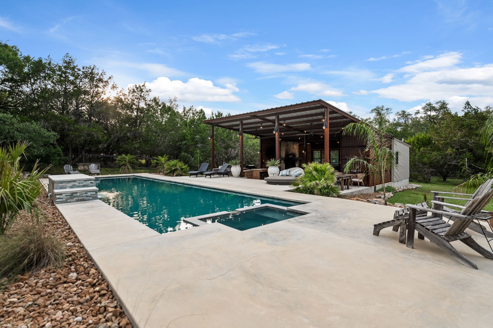 195 Desert Flower Spring Branch, TX 78070 - Photo 30 of 40 Rectangular swimming pool with integrated spa and concrete surround