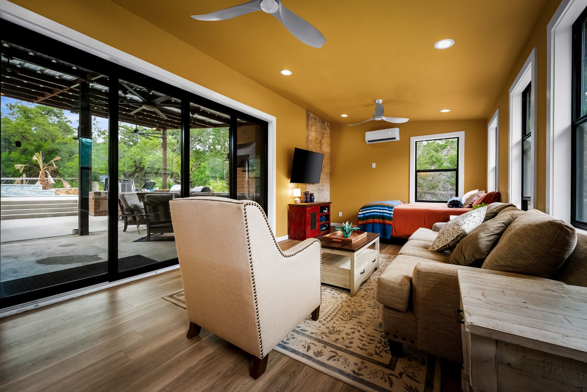 195 Desert Flower Spring Branch, TX 78070 - Photo 33 of 40 Spacious living area featuring wood-finish flooring, a vibrant accent wall, recessed lighting, and dual ceiling fans