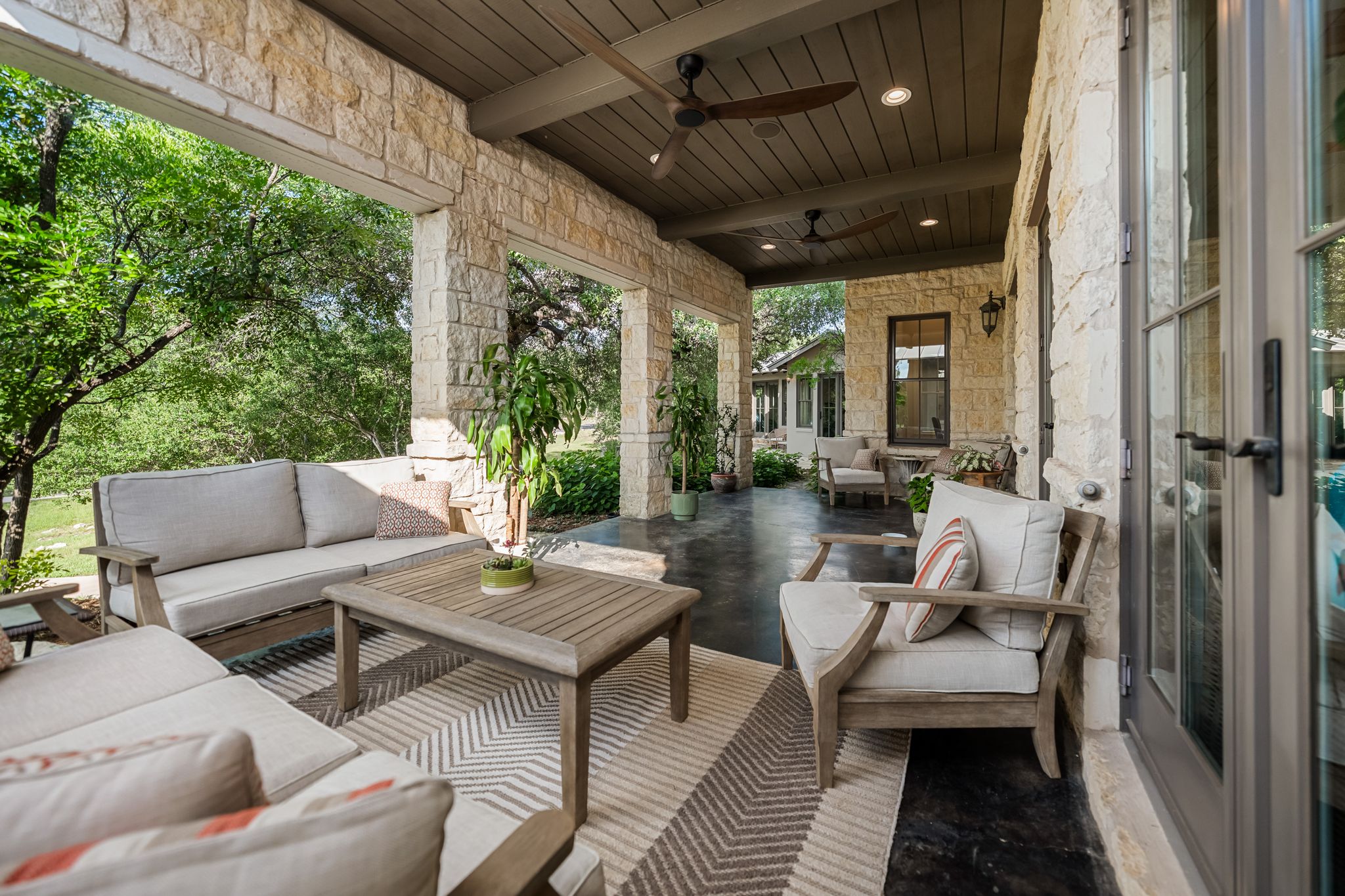 195 Desert Flower Spring Branch, TX 78070 - Photo 6 of 40 Covered outdoor patio featuring stone columns and exterior walls