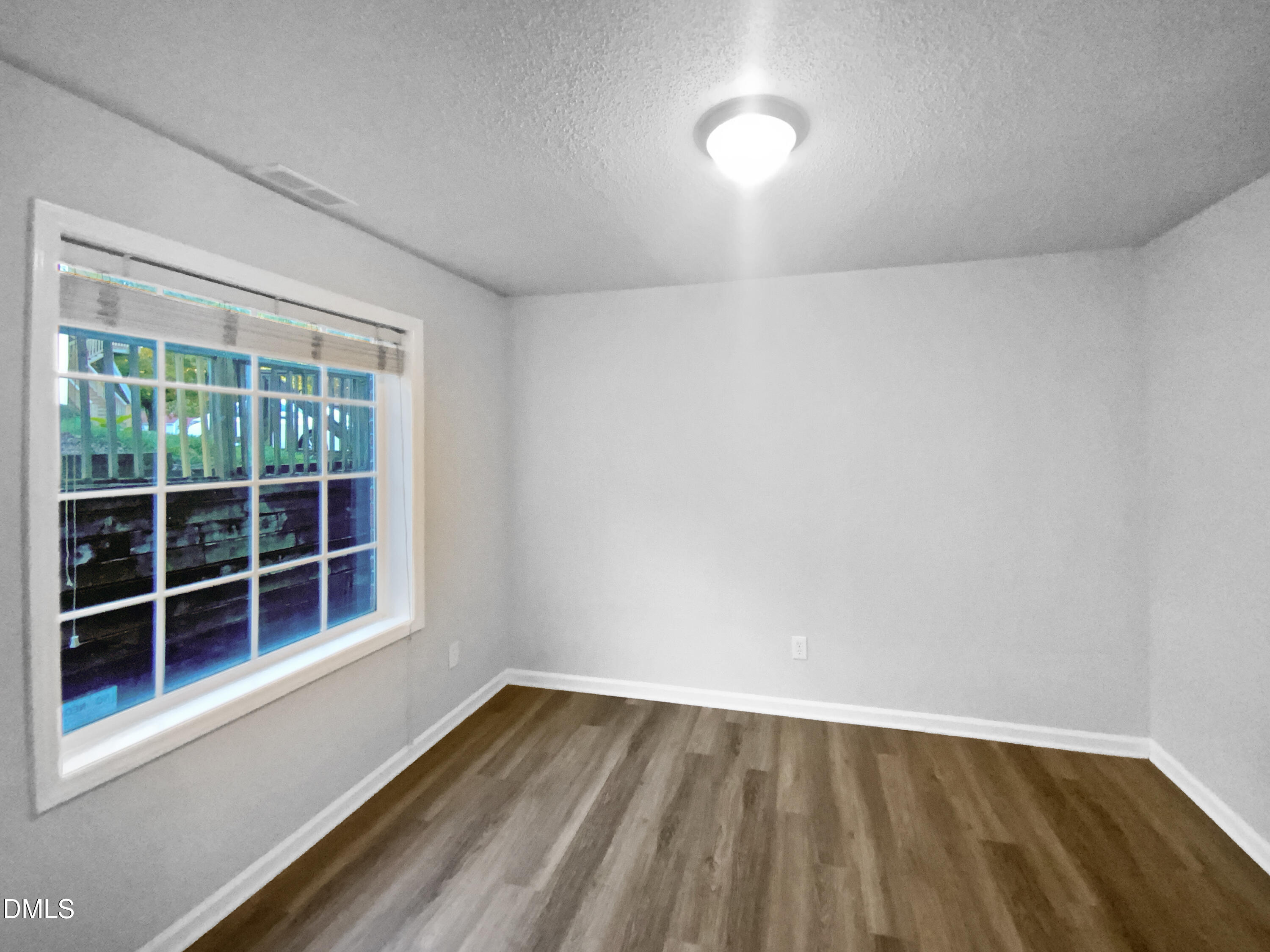 2201 Mountain Mist Court, Unit 103 Raleigh, NC 27603 - Photo 14 of 19 a view of empty room with wooden floor and fan