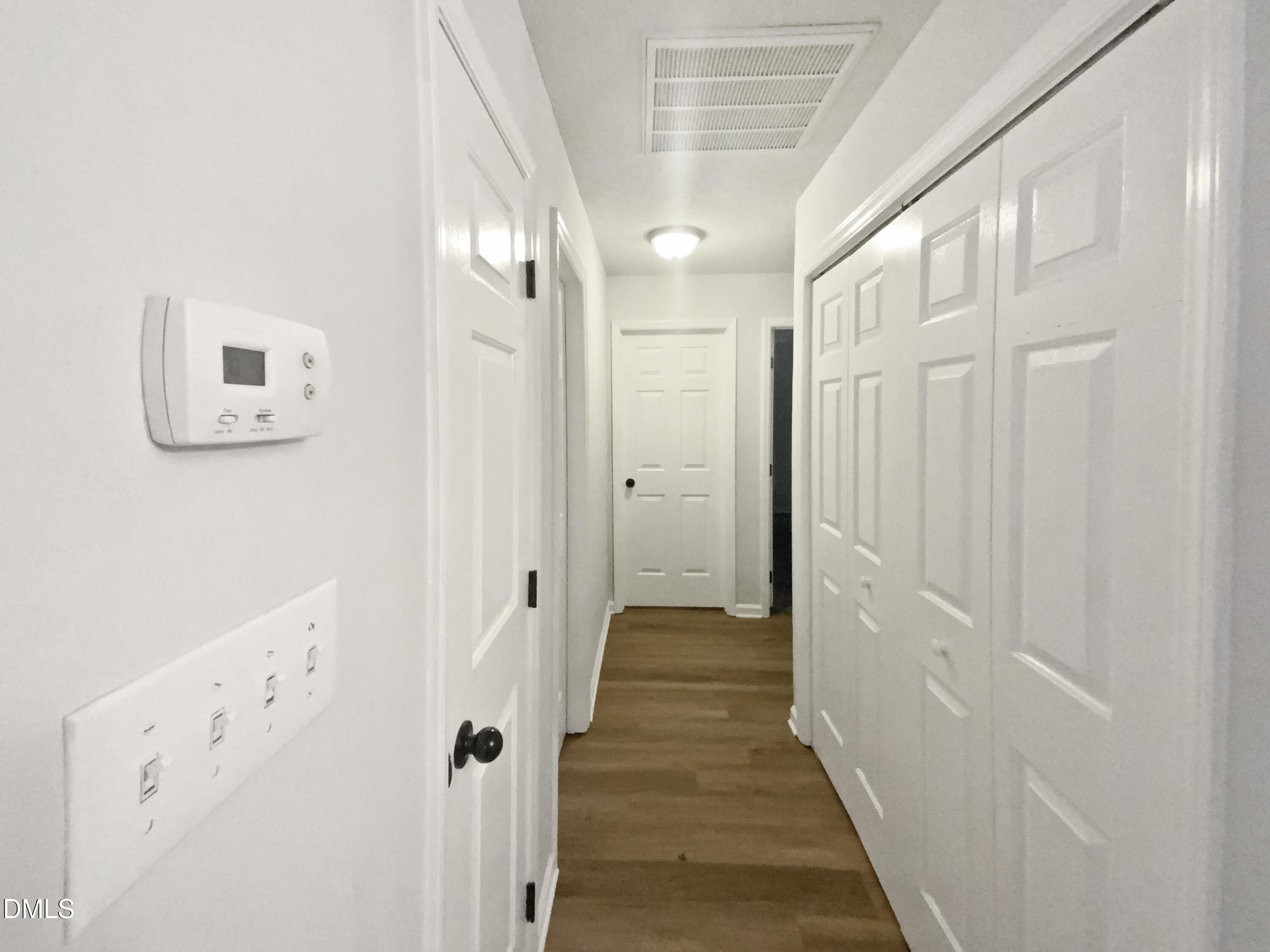 2201 Mountain Mist Court, Unit 103 Raleigh, NC 27603 - Photo 15 of 19 a view of a hallway with wooden floor and staircase