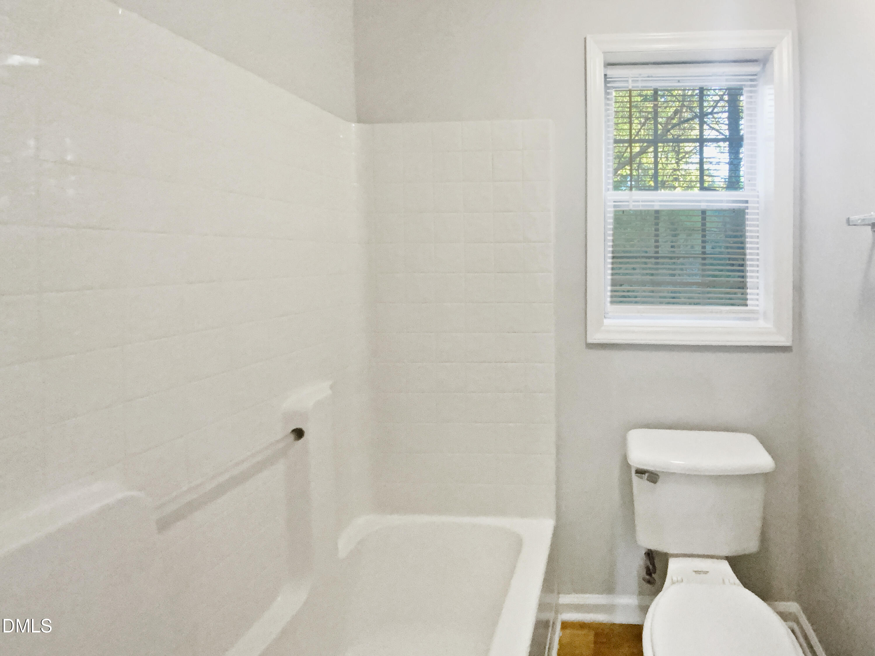 2201 Mountain Mist Court, Unit 103 Raleigh, NC 27603 - Photo 16 of 19 a white toilet sitting next to a bath tub