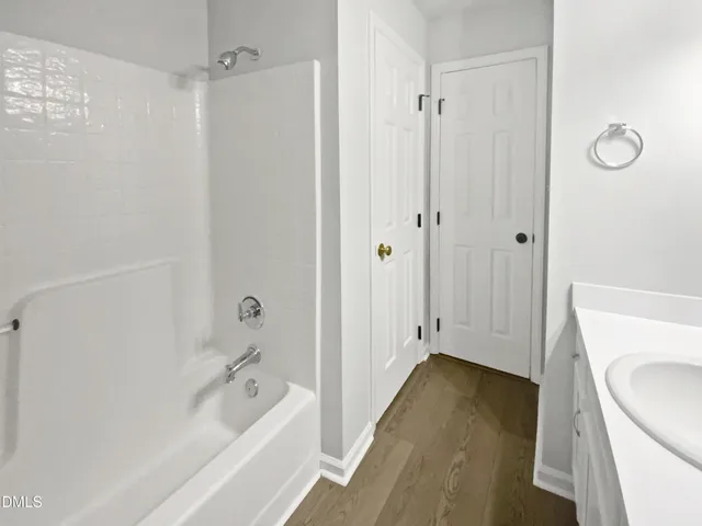 a bathroom with a tub sink and vanity