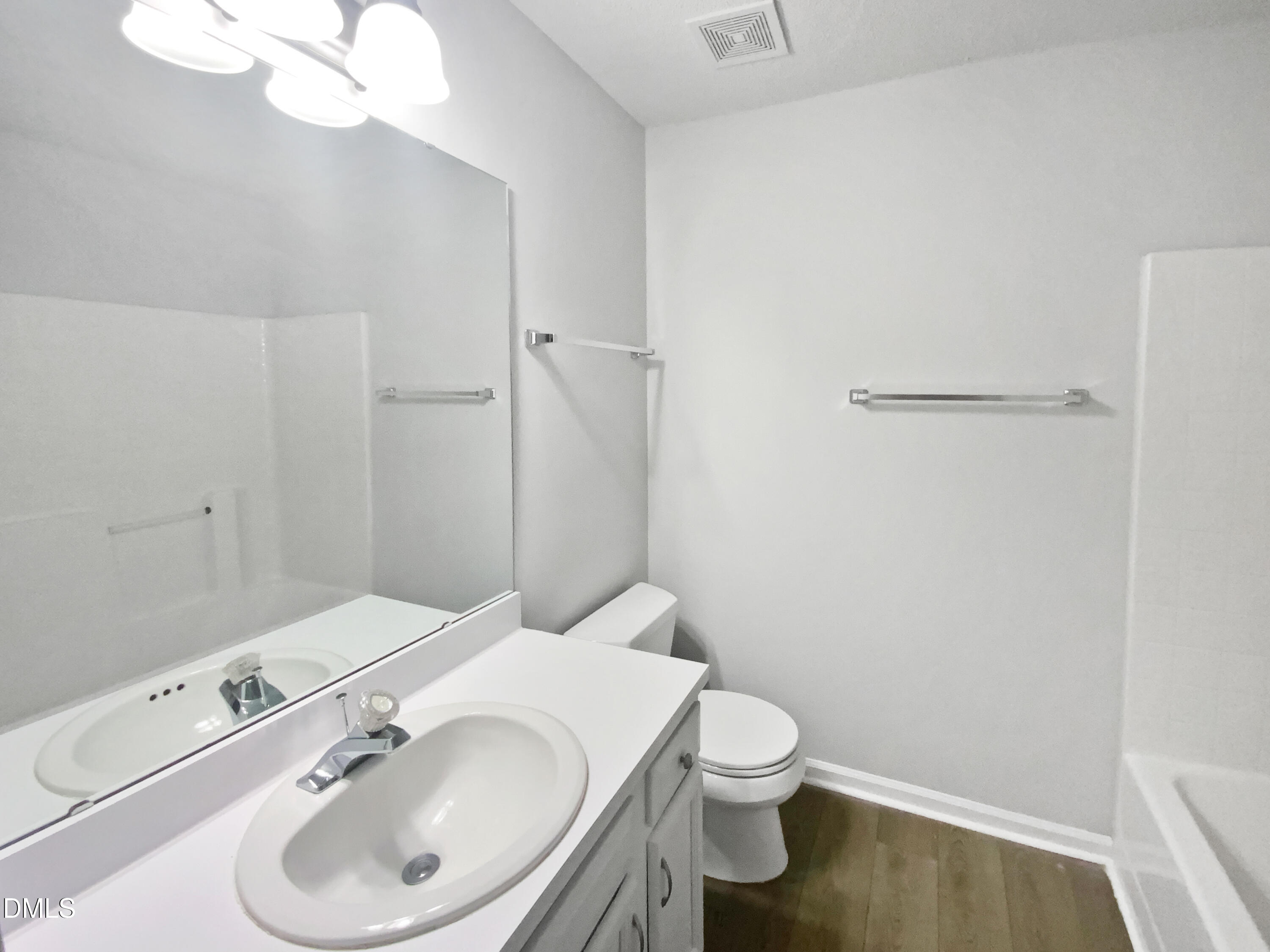2201 Mountain Mist Court, Unit 103 Raleigh, NC 27603 - Photo 18 of 19 a bathroom with a toilet sink and mirror