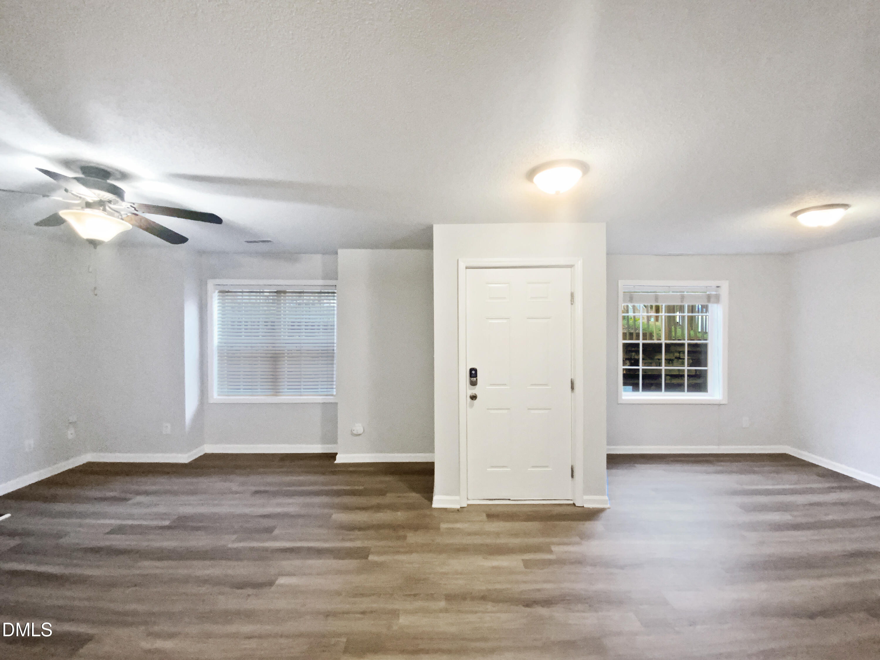 2201 Mountain Mist Court, Unit 103 Raleigh, NC 27603 - Photo 3 of 19 a view of an empty room with wooden floor and a window