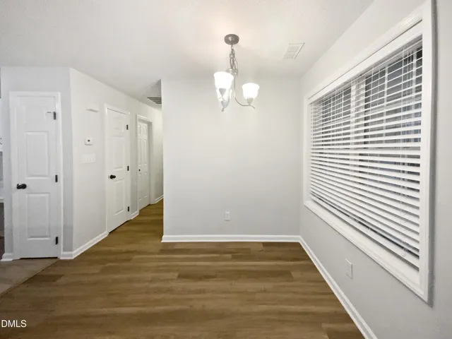 a view of a room with wooden floor and window