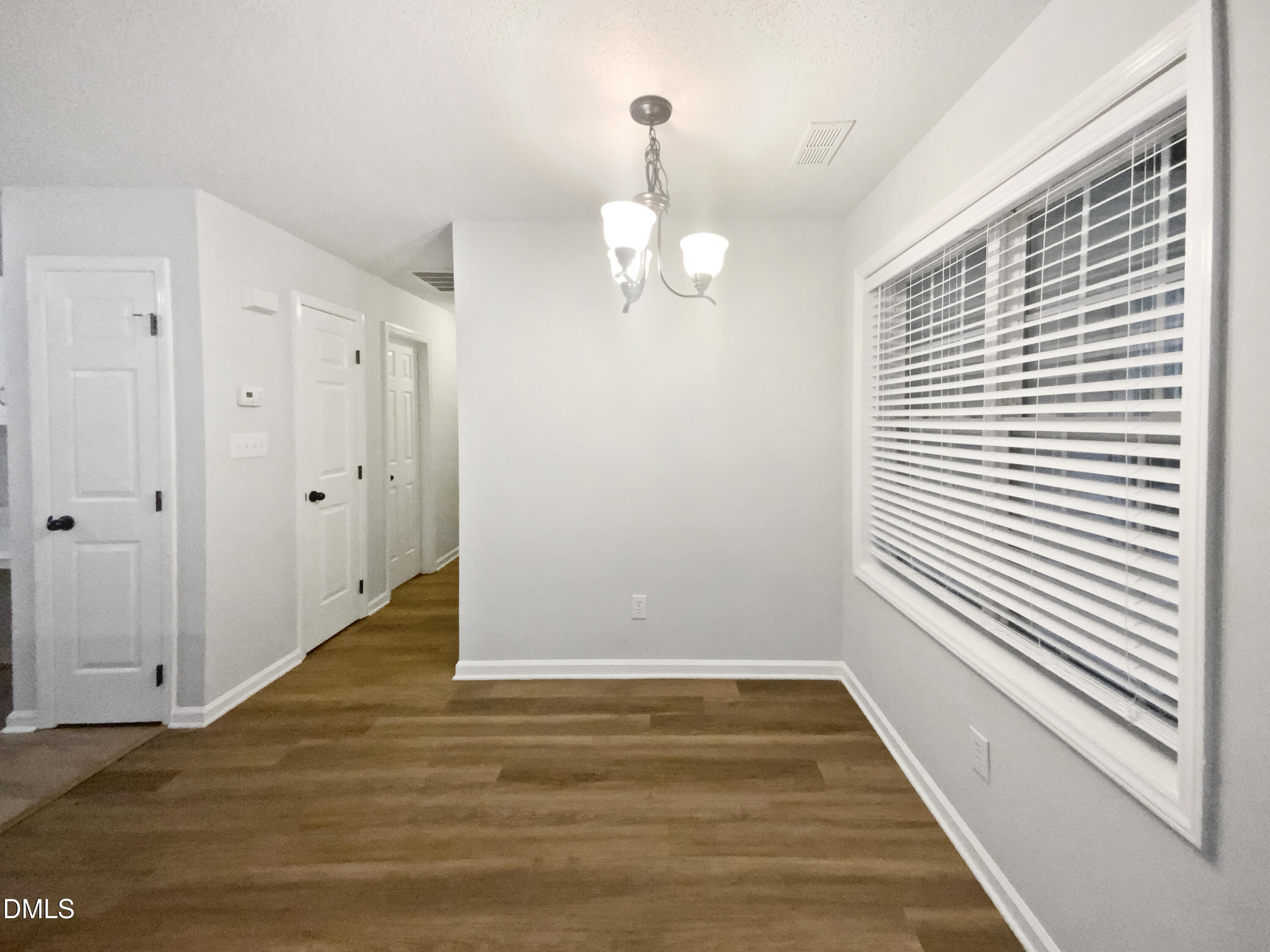 2201 Mountain Mist Court, Unit 103 Raleigh, NC 27603 - Photo 7 of 19 a view of a room with wooden floor and window