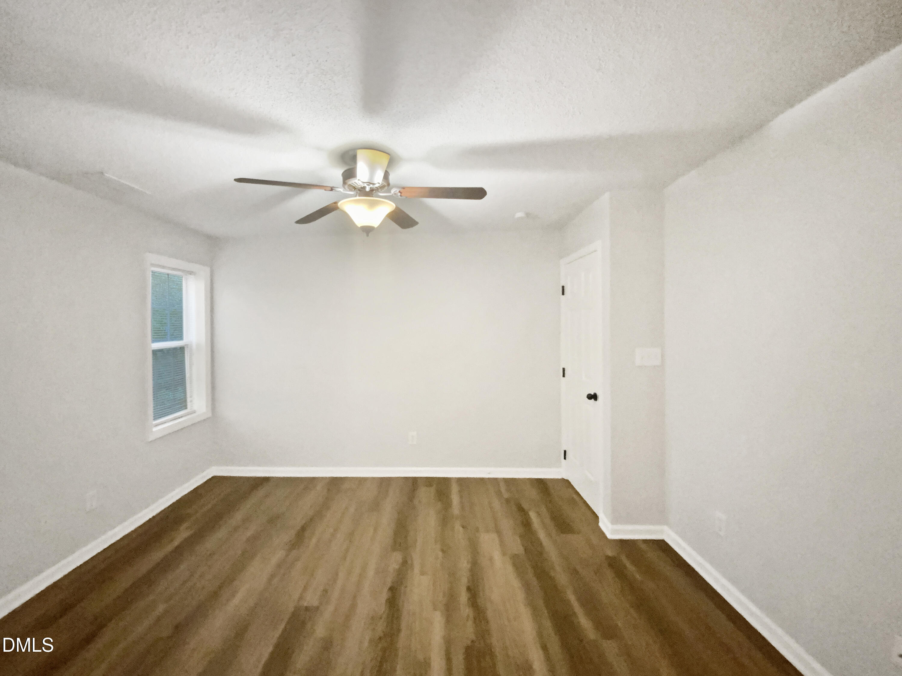 2201 Mountain Mist Court, Unit 103 Raleigh, NC 27603 - Photo 9 of 19 wooden floor in an empty room with a window